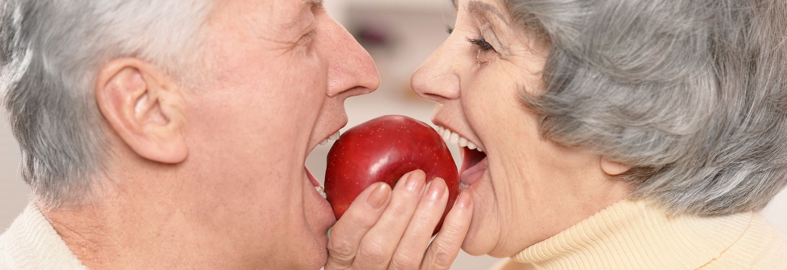 Mature couple eating an apple